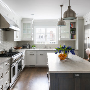 Mid-sized transitional open concept kitchen designs - Open concept kitchen - mid-sized transitional l-shaped dark wood floor open concept kitchen idea in New York with an undermount sink, shaker cabinets, white cabinets, quartzite countertops, gray backsplash, ceramic backsplash, stainless steel appliances and an island