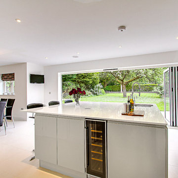 Large contemporary island with large bifold doors opening out onto the garden