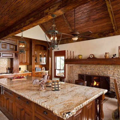 Eat-in kitchen - rustic eat-in kitchen idea in Dallas with raised-panel cabinets, medium tone wood cabinets and beige backsplash