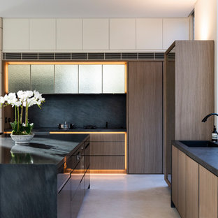 Large contemporary l-shaped kitchen in Sydney with flat-panel cabinets, medium wood cabinets, quartz benchtops, black splashback, marble splashback, stainless steel appliances, ceramic floors, with island, white floor, black benchtop and an undermount sink.