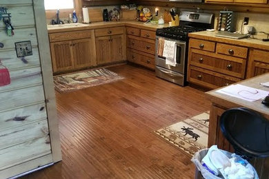 Large minimalist u-shaped light wood floor and brown floor open concept kitchen photo in Nashville