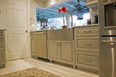Example of a mid-sized transitional galley porcelain tile and white floor kitchen pantry design in Tampa with a farmhouse sink, raised-panel cabinets, gray cabinets, quartzite countertops, multicolored backsplash, stone slab backsplash, stainless steel appliances and no island