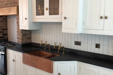 Inspiration for a traditional kitchen/diner in Other with a belfast sink, shaker cabinets, white cabinets, coloured appliances and light hardwood flooring.
