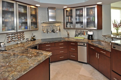Mid-sized trendy u-shaped marble floor eat-in kitchen photo in Miami with an undermount sink, glass-front cabinets, medium tone wood cabinets, quartzite countertops, metallic backsplash, glass tile backsplash, stainless steel appliances and a peninsula