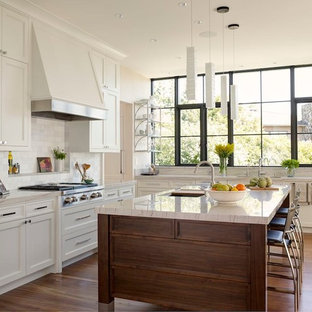 Transitional kitchen remodeling - Kitchen - transitional l-shaped medium tone wood floor kitchen idea in Seattle with an undermount sink, shaker cabinets, white cabinets, white backsplash, stainless steel appliances and an island