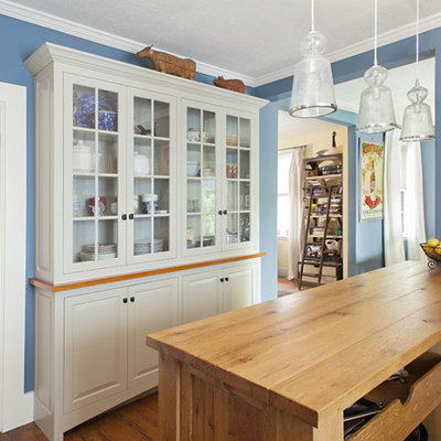 Open concept kitchen - traditional open concept kitchen idea in Boston with glass-front cabinets, gray cabinets and wood countertops