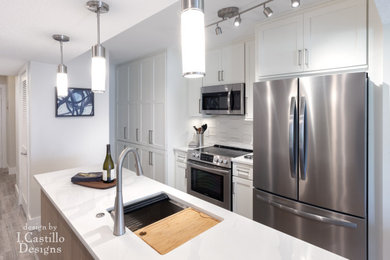 Example of a small trendy galley ceramic tile and gray floor eat-in kitchen design in Jacksonville with a single-bowl sink, shaker cabinets, white cabinets, quartz countertops, white backsplash, cement tile backsplash, stainless steel appliances, an island and white countertops