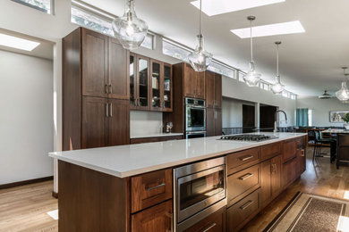 Eat-in kitchen - large modern light wood floor and brown floor eat-in kitchen idea in Other with shaker cabinets, medium tone wood cabinets, two islands and white countertops