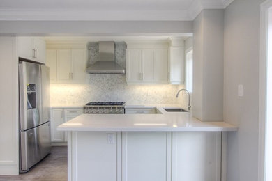 Inspiration for a small modern u-shaped kitchen remodel in Toronto with white cabinets and a peninsula