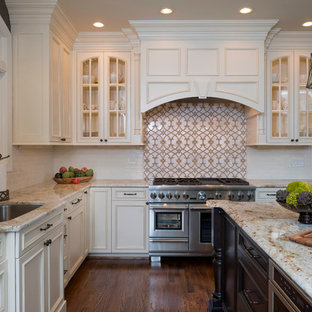 Mid-sized traditional eat-in kitchen designs - Inspiration for a mid-sized timeless l-shaped dark wood floor and brown floor eat-in kitchen remodel in DC Metro with an undermount sink, recessed-panel cabinets, white cabinets, granite countertops, white backsplash, stainless steel appliances, an island and subway tile backsplash