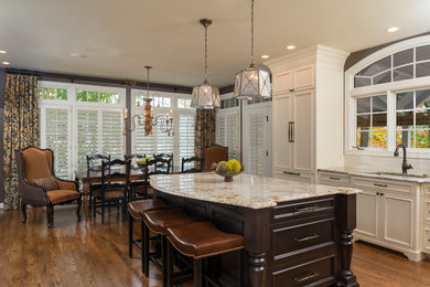 Inspiration for a mid-sized timeless l-shaped dark wood floor and brown floor eat-in kitchen remodel in DC Metro with an undermount sink, recessed-panel cabinets, dark wood cabinets, granite countertops, white backsplash, subway tile backsplash, paneled appliances and an island