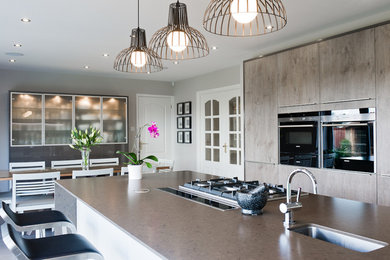 This is an example of a contemporary kitchen in London with an island.