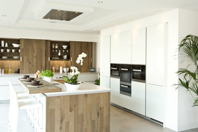 Design ideas for a medium sized contemporary open plan kitchen in Cheshire with dark wood cabinets, brown splashback, wood splashback and an island.