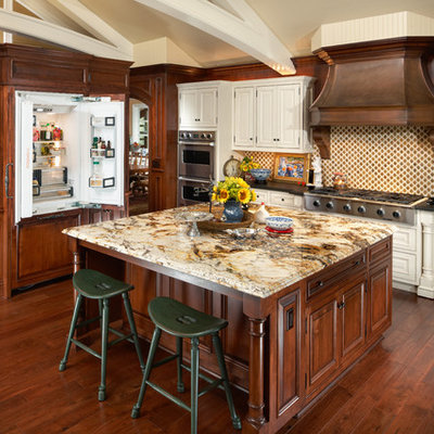 Elegant kitchen photo in Phoenix with raised-panel cabinets, paneled appliances and granite countertops
