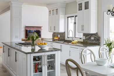 Eat-in kitchen - traditional multicolored floor eat-in kitchen idea in Chicago with an undermount sink, recessed-panel cabinets, white cabinets, window backsplash, an island and multicolored countertops