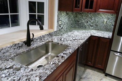 Kitchen - mid-sized traditional kitchen idea in Providence with an undermount sink, granite countertops, blue backsplash, stone slab backsplash, stainless steel appliances and an island