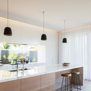 Inspiration for a scandinavian galley light wood floor kitchen remodel in Sydney with an undermount sink, white cabinets, marble countertops, an island, flat-panel cabinets and glass sheet backsplash