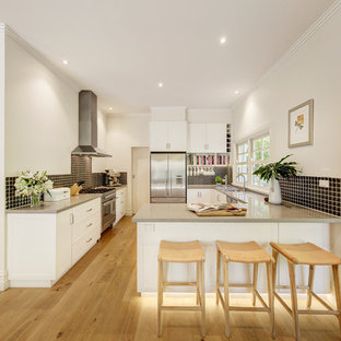 Design ideas for a traditional l-shaped eat-in kitchen in Melbourne with an undermount sink, white cabinets, granite benchtops, ceramic splashback and stainless steel appliances.