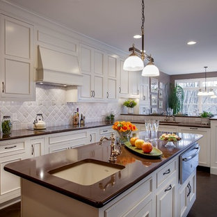 Photo of a large transitional l-shaped eat-in kitchen in Philadelphia with an undermount sink, recessed-panel cabinets, white cabinets, grey splashback, ceramic splashback, with island, quartz benchtops, stainless steel appliances and slate floors.