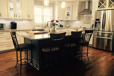 Inspiration for a transitional l-shaped kitchen remodel in Other with shaker cabinets, white cabinets and an island