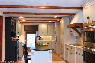 Eat-in kitchen - mid-sized rustic u-shaped light wood floor eat-in kitchen idea in Louisville with an undermount sink, recessed-panel cabinets, white cabinets, solid surface countertops, gray backsplash, ceramic backsplash, stainless steel appliances and an island