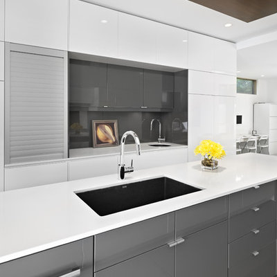 Minimalist kitchen photo in Edmonton with flat-panel cabinets, gray cabinets, gray backsplash and glass sheet backsplash