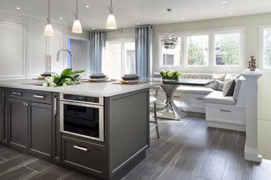 Eat-in kitchen - traditional porcelain tile eat-in kitchen idea in Edmonton with recessed-panel cabinets, gray cabinets, quartzite countertops and an island