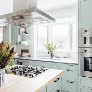 Mid-sized arts and crafts kitchen in Salt Lake City with an integrated sink, shaker cabinets, green cabinets, solid surface benchtops, stainless steel appliances, cement tiles, with island, grey floor and grey benchtop.