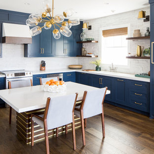Eat-in kitchen remodeling - Eat-in kitchen - dark wood floor and brown floor eat-in kitchen idea in Orange County with shaker cabinets, blue cabinets, paneled appliances, no island and white countertops