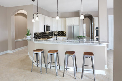 Eat-in kitchen - mid-sized transitional u-shaped porcelain tile and beige floor eat-in kitchen idea in Austin with an undermount sink, raised-panel cabinets, white cabinets, granite countertops, gray backsplash, glass tile backsplash, stainless steel appliances, an island and white countertops