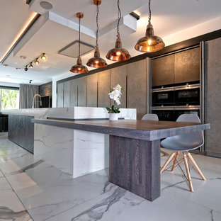 Medium sized contemporary single-wall kitchen in Surrey with flat-panel cabinets, grey cabinets, marble worktops, marble flooring, an island, white floors and black appliances.