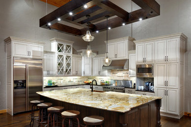 Large transitional l-shaped dark wood floor open concept kitchen photo in Chicago with a farmhouse sink, raised-panel cabinets, granite countertops, beige backsplash, stone tile backsplash, stainless steel appliances and an island