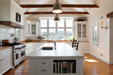 Inspiration for a country kitchen remodel in Philadelphia with recessed-panel cabinets, white cabinets, white backsplash, subway tile backsplash and stainless steel appliances