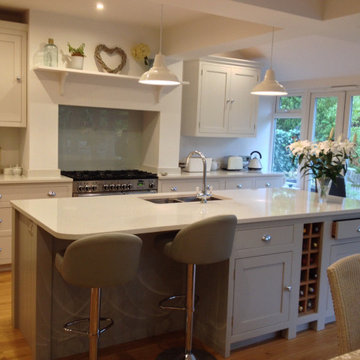 Light grey classic kitchen with beaded cabinets and large island