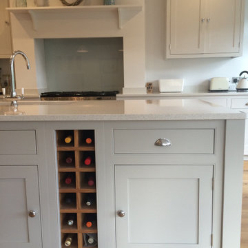 Light grey classic kitchen with beaded cabinets and large island