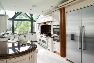 Photo of a classic l-shaped kitchen/diner in Other with a submerged sink, recessed-panel cabinets, grey cabinets, granite worktops, stainless steel appliances, porcelain flooring and an island.