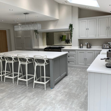 Light grey hand painted kitchen with large island and white quartz worktops