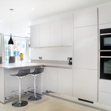 Light grey handle-less kitchen with built in appliances