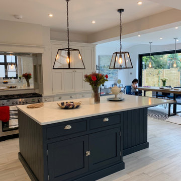 Light grey handmade kitchen, dark blue island with larder tops, white worktops &