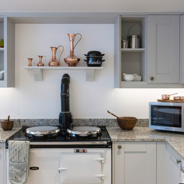 Light Grey Shaker style U shape fitted kitchen with Amrbosia White Granite