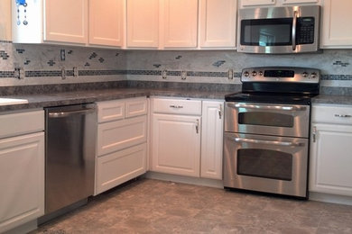 limestone backsplash with glass tile accent