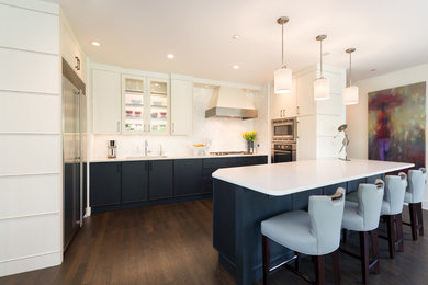 Inspiration for a large contemporary u-shaped dark wood floor and brown floor open concept kitchen remodel in Chicago with an undermount sink, flat-panel cabinets, blue cabinets, quartz countertops, white backsplash, marble backsplash, stainless steel appliances, an island and white countertops