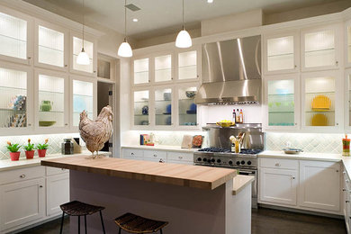 Kitchen - mid-sized transitional u-shaped dark wood floor kitchen idea in Los Angeles with shaker cabinets, white cabinets, wood countertops, blue backsplash, subway tile backsplash, stainless steel appliances and an island