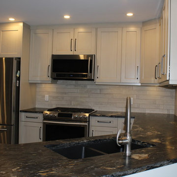 Linen kitchen with leathered granite island and countertops
