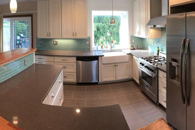 Eat-in kitchen - mid-sized contemporary l-shaped vinyl floor and gray floor eat-in kitchen idea in Portland with a farmhouse sink, recessed-panel cabinets, white cabinets, laminate countertops, blue backsplash, subway tile backsplash, stainless steel appliances and no island