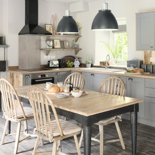Design ideas for a small farmhouse kitchen/diner in Other with grey floors.