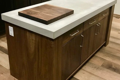 Inspiration for a contemporary kitchen remodel in Phoenix with flat-panel cabinets, medium tone wood cabinets, concrete countertops and gray countertops