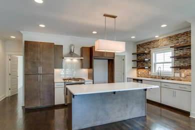 Eat-in kitchen - mid-sized industrial l-shaped medium tone wood floor eat-in kitchen idea in Nashville with an undermount sink, flat-panel cabinets, medium tone wood cabinets, quartzite countertops, white backsplash, subway tile backsplash, stainless steel appliances and an island