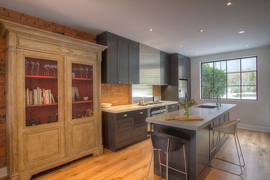 Eat-in kitchen - modern single-wall light wood floor eat-in kitchen idea in Toronto with shaker cabinets, gray cabinets, marble countertops and an island