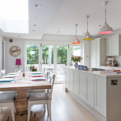 Kitchen - transitional light wood floor kitchen idea in London with shaker cabinets, gray cabinets, white backsplash and subway tile backsplash